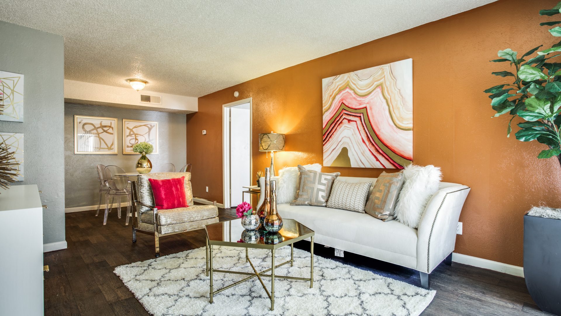 a living room with orange walls and white furniture at The Hive